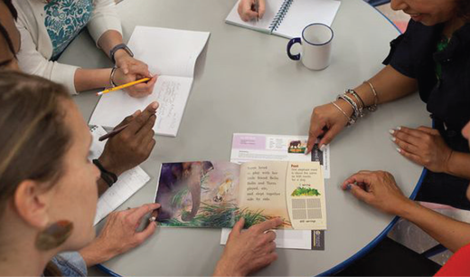 Teachers discussing a Shared Reading book.